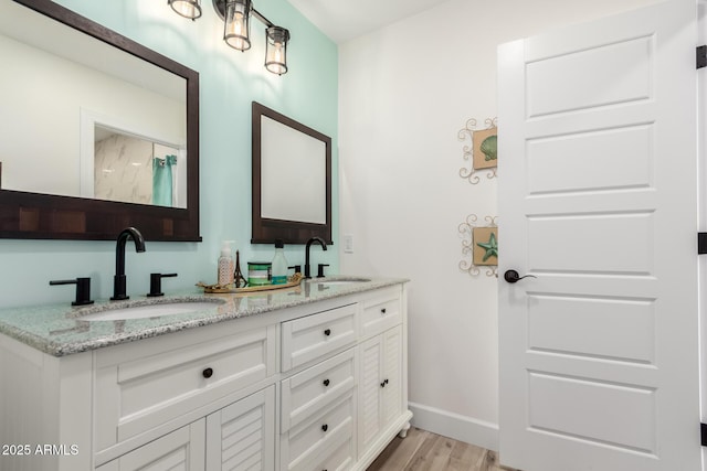 675 Val Verde Cir W, Litchfield Park, AZ 85340 - full bath with wood finished floors, baseboards, and double vanity