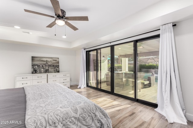 675 Val Verde Cir W, Litchfield Park, AZ 85340 - bedroom with access to exterior, light wood-style flooring, a tray ceiling, and ceiling fan