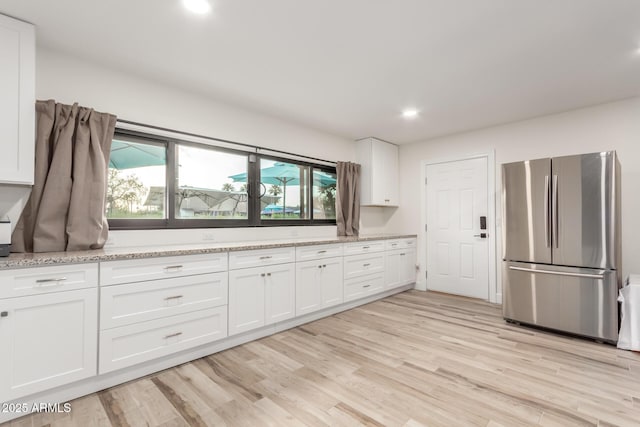 675 Val Verde Cir W, Litchfield Park, AZ 85340 - kitchen featuring freestanding refrigerator, white cabinets, plenty of natural light, and recessed lighting