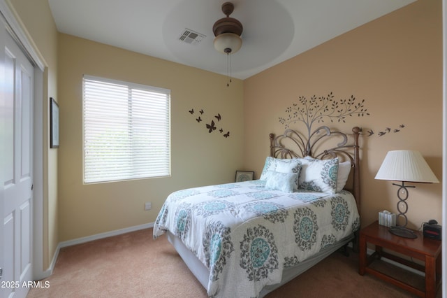 bedroom featuring a closet, light colored carpet, visible vents, a ceiling fan, and baseboards