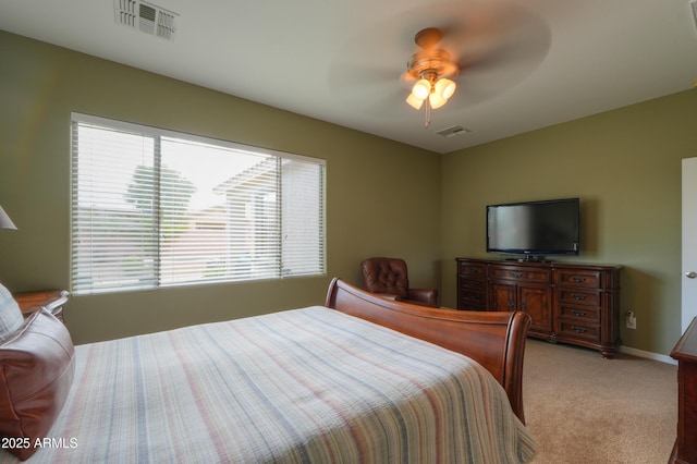 bedroom with light colored carpet, visible vents, ceiling fan, and baseboards