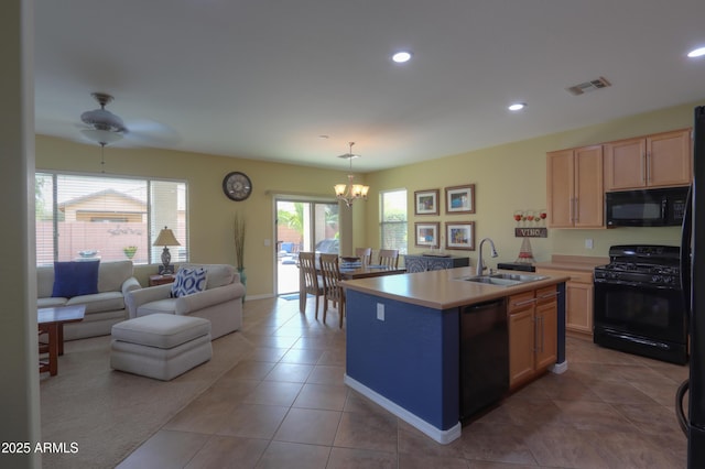 kitchen featuring recessed lighting, light countertops, a sink, tile patterned flooring, and black appliances