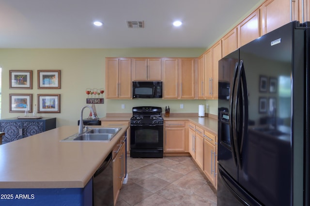 kitchen featuring a sink, visible vents, light countertops, light brown cabinetry, and black appliances