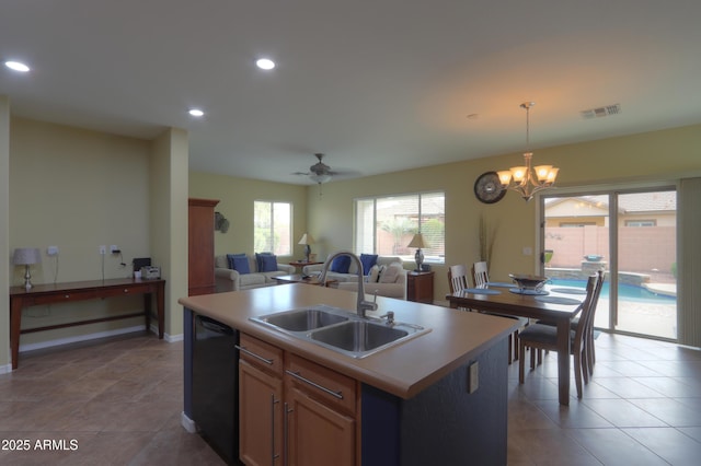 kitchen featuring black dishwasher, decorative light fixtures, visible vents, open floor plan, and a sink