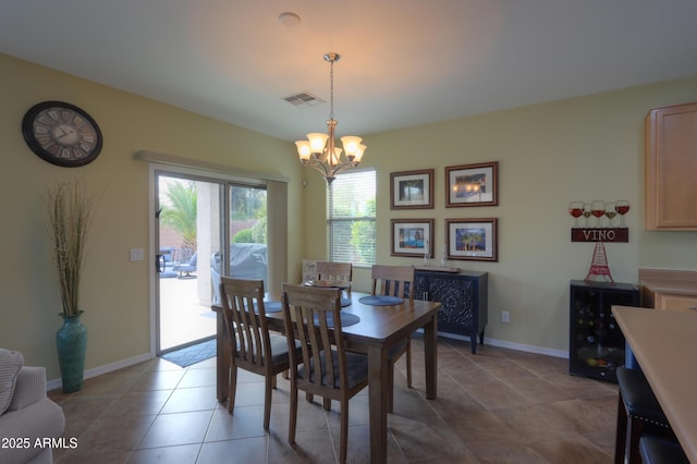 tiled dining area featuring a chandelier, wine cooler, visible vents, and baseboards