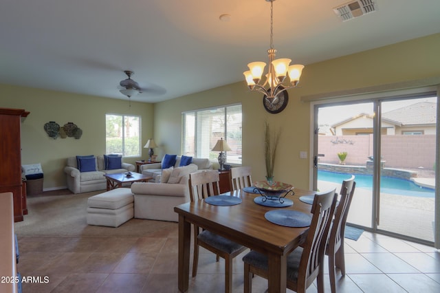 dining room featuring visible vents, a notable chandelier, and light tile patterned floors