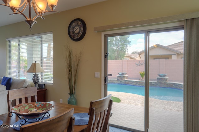 dining space featuring a notable chandelier and a healthy amount of sunlight