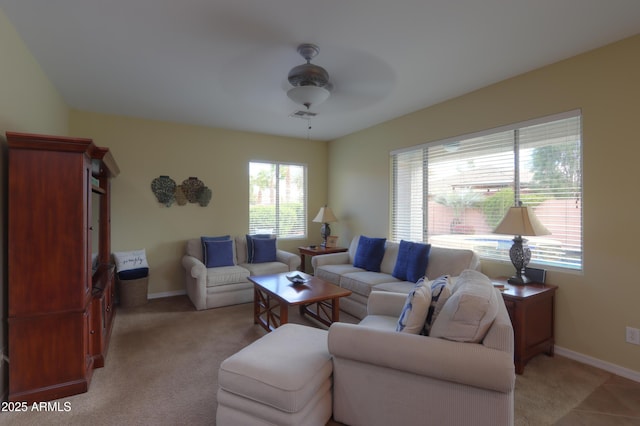 living area featuring light carpet, ceiling fan, visible vents, and baseboards