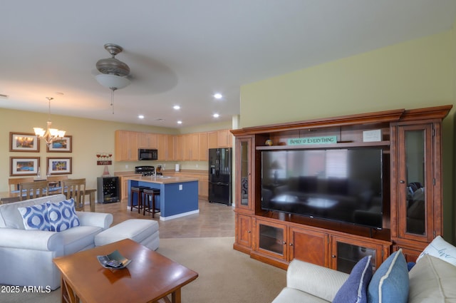 living room with recessed lighting, light carpet, and ceiling fan with notable chandelier