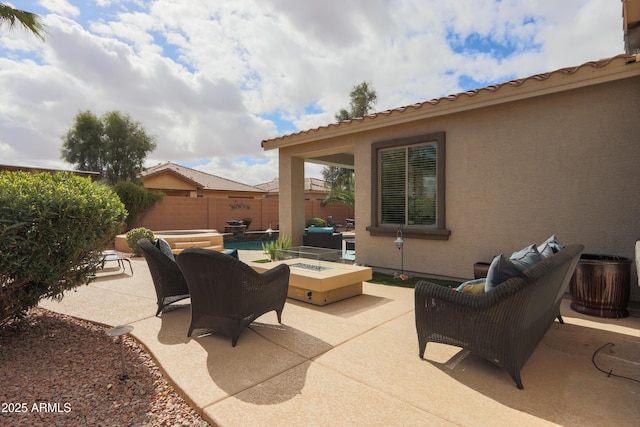 view of patio / terrace with a fenced in pool, fence, and a fire pit