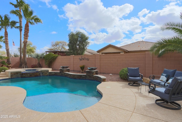 view of pool with a fenced backyard, a pool with connected hot tub, and a patio