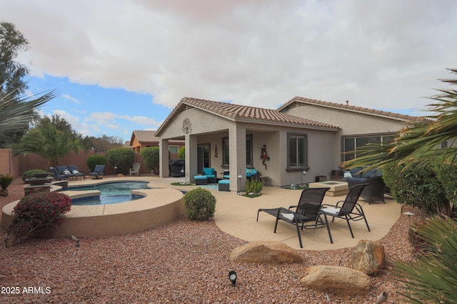 back of property featuring a patio area, an outdoor living space with a fire pit, and stucco siding