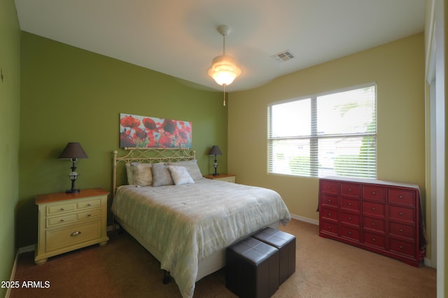 carpeted bedroom featuring visible vents and baseboards