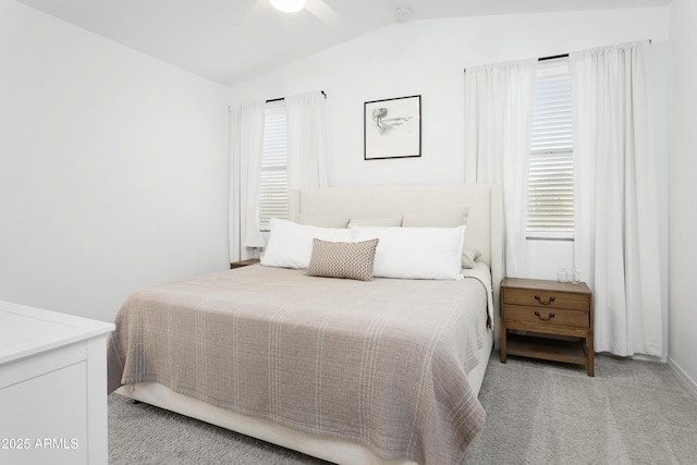 bedroom featuring ceiling fan, light carpet, and lofted ceiling