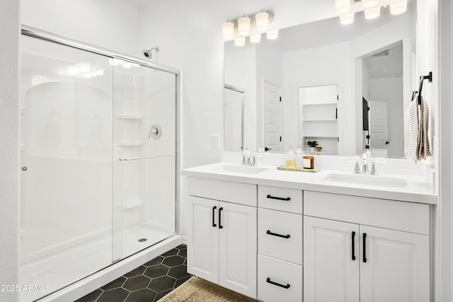 bathroom featuring a shower with shower door, tile patterned floors, and vanity