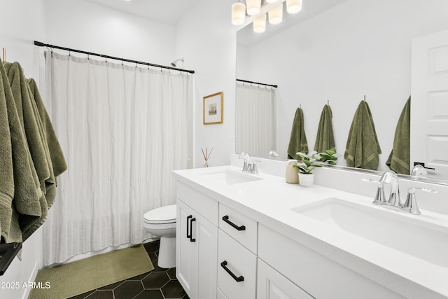 bathroom with toilet, tile patterned flooring, and vanity