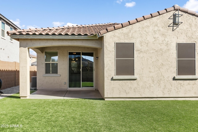 rear view of property with central air condition unit, a patio area, and a lawn