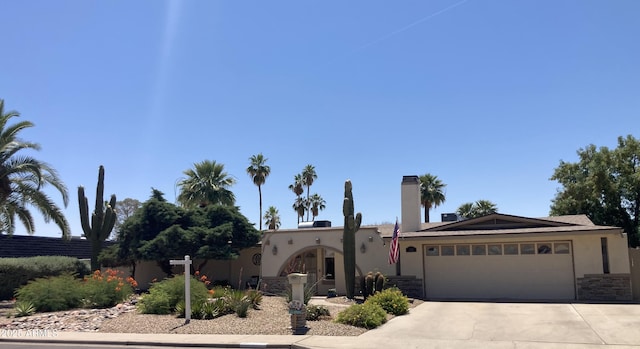 2125 E Elmwood St, Mesa, AZ 85213 - view of front of property with stucco siding, a garage, driveway, and stone siding