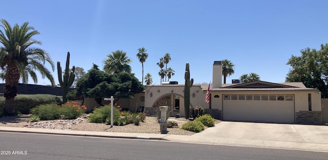 2125 E Elmwood St, Mesa, AZ 85213 - view of front of home with stucco siding, driveway, an attached garage, and stone siding