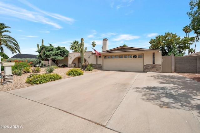 2125 E Elmwood St, Mesa, AZ 85213 - view of front of property with stucco siding, a garage, concrete driveway, and stone siding