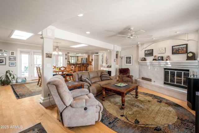 2125 E Elmwood St, Mesa, AZ 85213 - living room featuring wood finished floors, a fireplace, a ceiling fan, ornate columns, and ornamental molding
