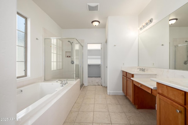 15469 W Dreyfus St, Surprise, AZ 85379 - bathroom with a shower stall, vanity, a garden tub, a walk in closet, and tile patterned floors