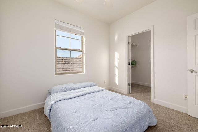 15469 W Dreyfus St, Surprise, AZ 85379 - carpeted bedroom with a walk in closet, baseboards, and a ceiling fan