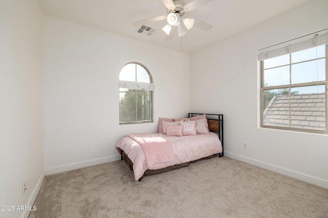 15469 W Dreyfus St, Surprise, AZ 85379 - carpeted bedroom featuring multiple windows, baseboards, and ceiling fan
