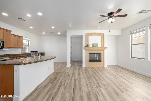 15469 W Dreyfus St, Surprise, AZ 85379 - kitchen with stainless steel microwave, recessed lighting, light wood-type flooring, baseboards, and a ceiling fan