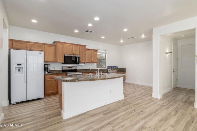 15469 W Dreyfus St, Surprise, AZ 85379 - kitchen with white fridge with ice dispenser, stainless steel range with electric cooktop, light wood-style floors, brown cabinets, and recessed lighting