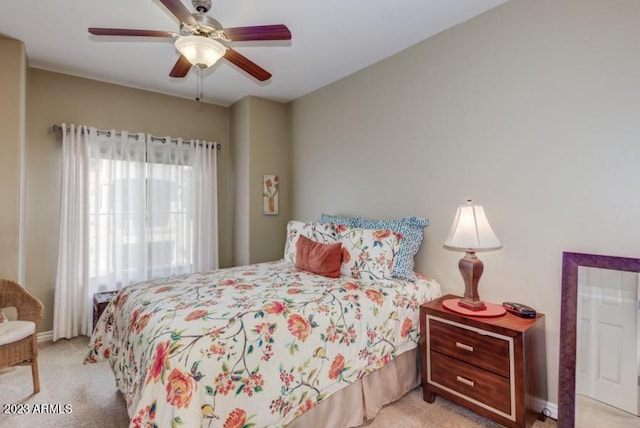 bedroom featuring ceiling fan and light carpet