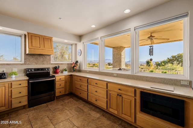 kitchen featuring ceiling fan, backsplash, electric range, and black microwave