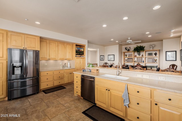 kitchen featuring ceiling fan, sink, appliances with stainless steel finishes, light brown cabinets, and light stone counters