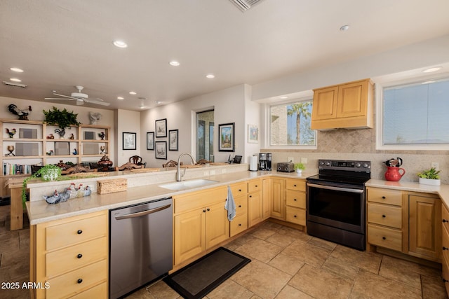 kitchen featuring ceiling fan, kitchen peninsula, light brown cabinets, and stainless steel appliances