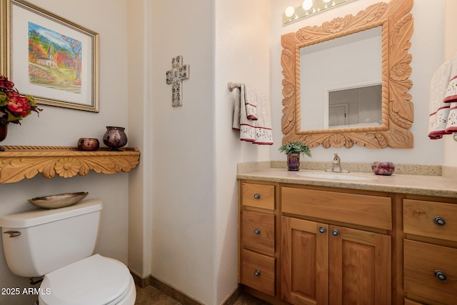 bathroom featuring toilet and vanity