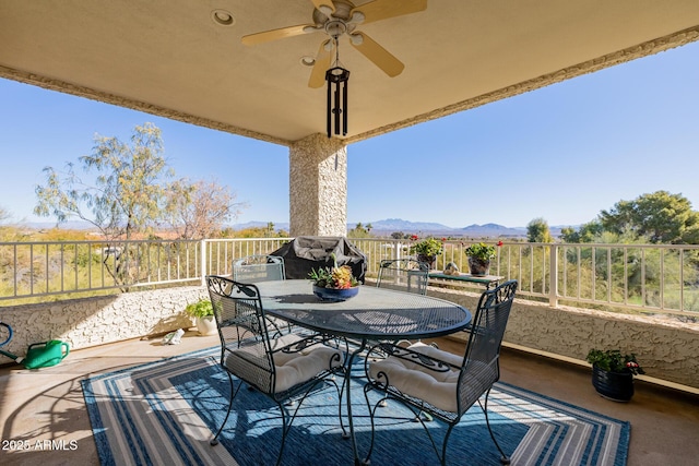 exterior space featuring a mountain view, grilling area, and ceiling fan