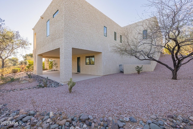 view of side of home featuring a patio