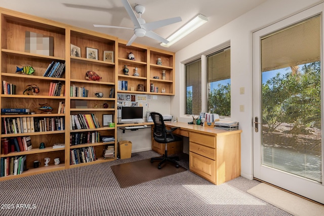 office area with ceiling fan and built in desk