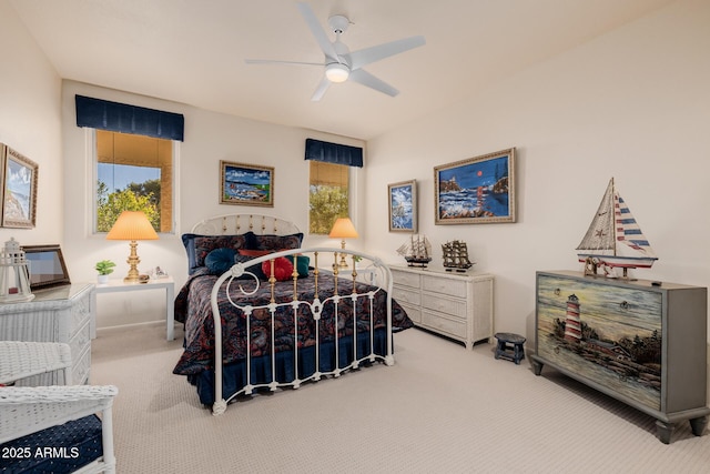 carpeted bedroom with ceiling fan and multiple windows