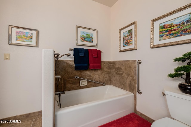 bathroom featuring toilet, a bathtub, and tile patterned floors