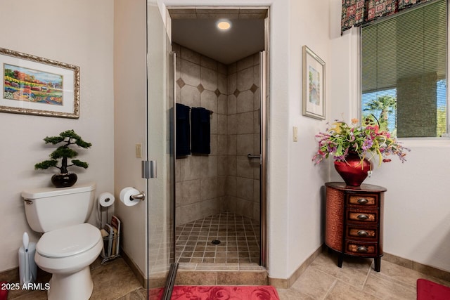 bathroom with toilet and walk in shower