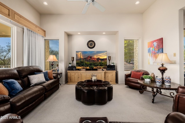 living room with ceiling fan and light colored carpet