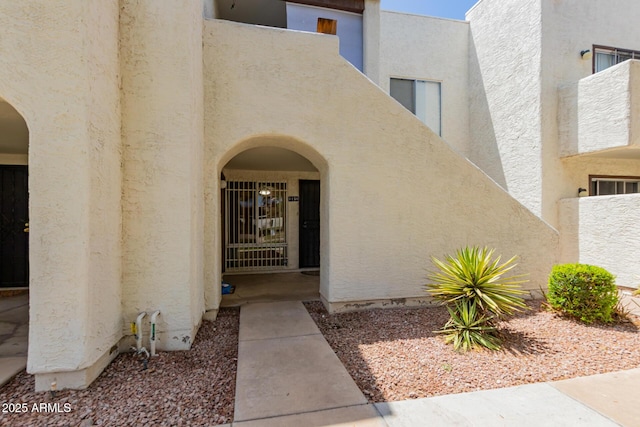 doorway to property with stucco siding