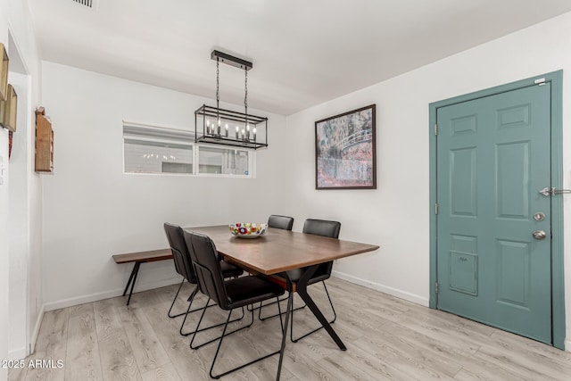 1814 W Thomas Rd, Phoenix, AZ 85015 - dining space with a chandelier, light wood-style flooring, and baseboards