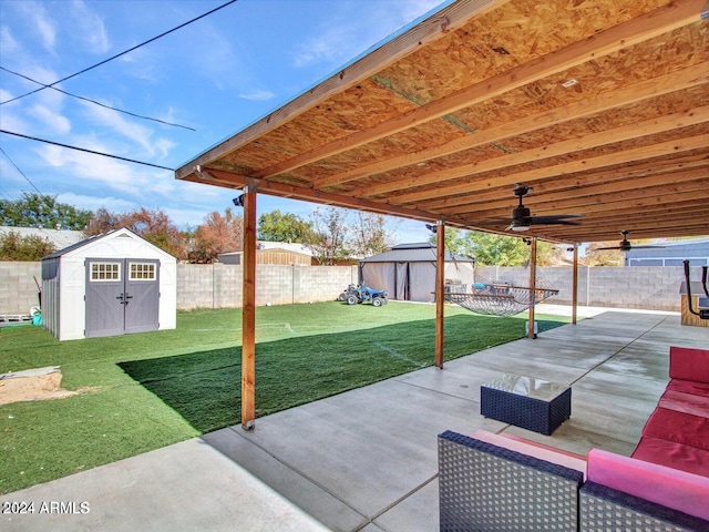 view of patio / terrace with ceiling fan and a storage shed