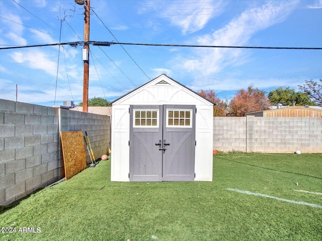 view of outbuilding with a lawn