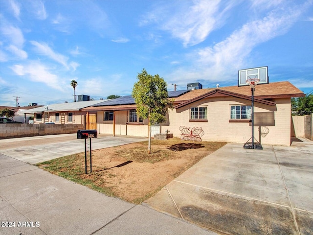 ranch-style home with solar panels