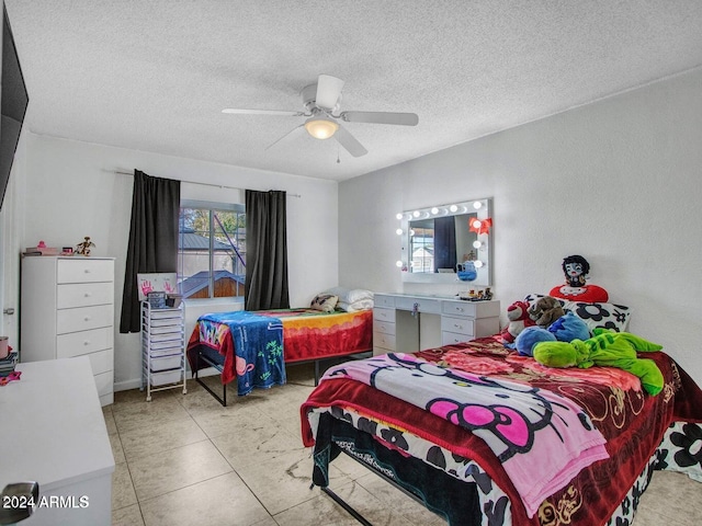 tiled bedroom with a textured ceiling and ceiling fan