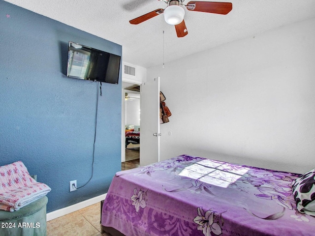 tiled bedroom featuring ceiling fan