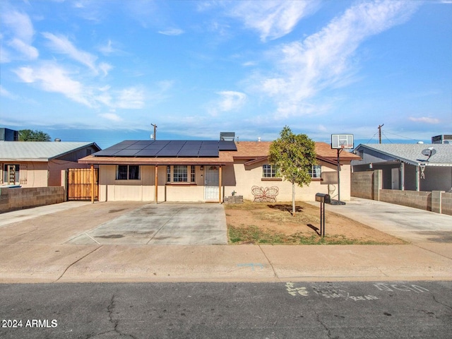 ranch-style house featuring solar panels